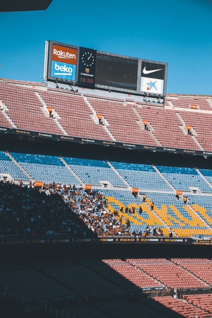 Crafting Captivating Headlines: Your awesome post title goes here A large stadium with sparse spectators under bright sunlight, showcasing empty seats.