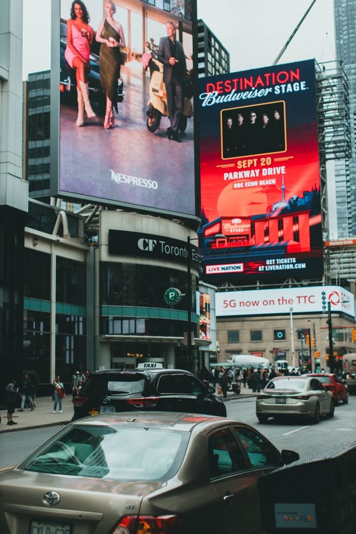 Our Services Dynamic city street scene featuring billboards and bustling traffic at CF Toronto Eaton Centre.